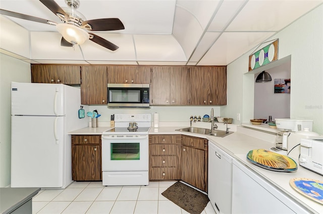 kitchen with sink, white appliances, ceiling fan, and light tile patterned floors