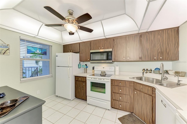 kitchen featuring sink, white appliances, ceiling fan, and light tile patterned floors