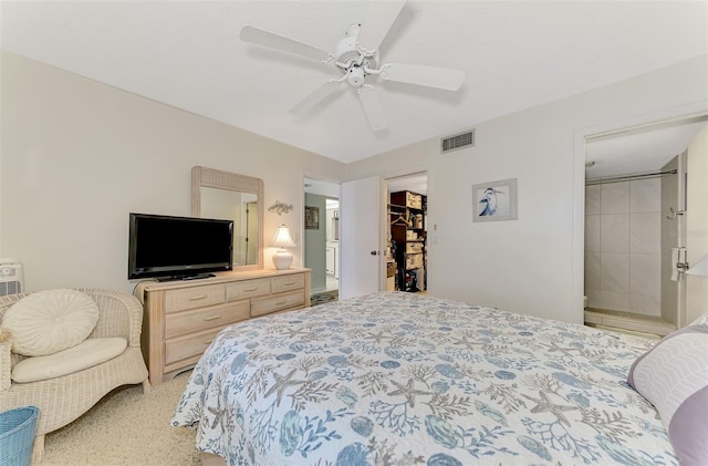 bedroom with ensuite bathroom, ceiling fan, a closet, and a walk in closet