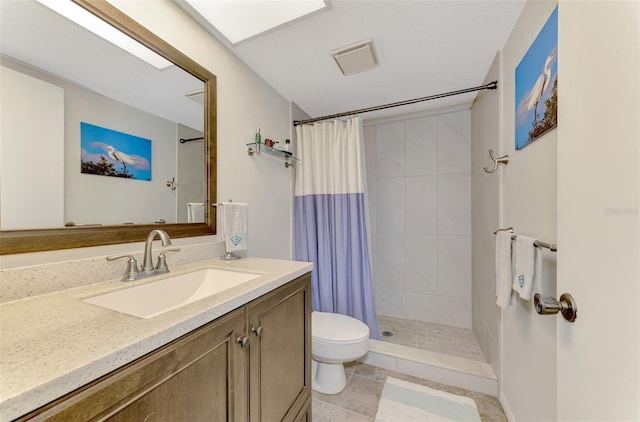 bathroom with toilet, vanity, tile patterned flooring, and a shower with shower curtain