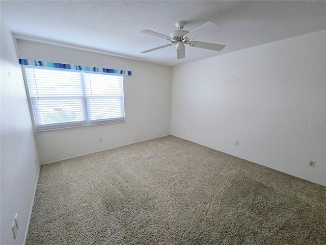 carpeted spare room with ceiling fan and a textured ceiling