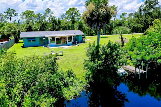 back of house featuring a patio, a water view, and a lawn