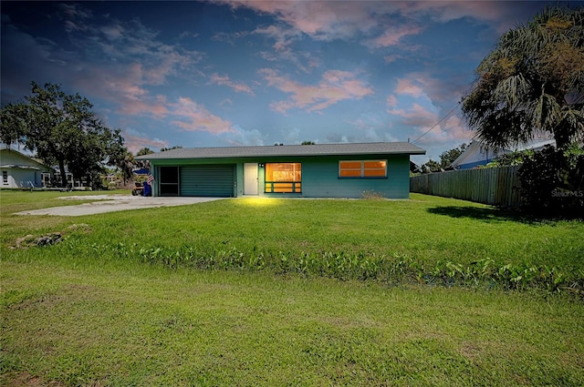 ranch-style house with a lawn and a garage