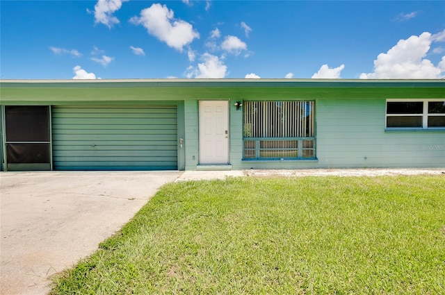 single story home with a front yard and a garage