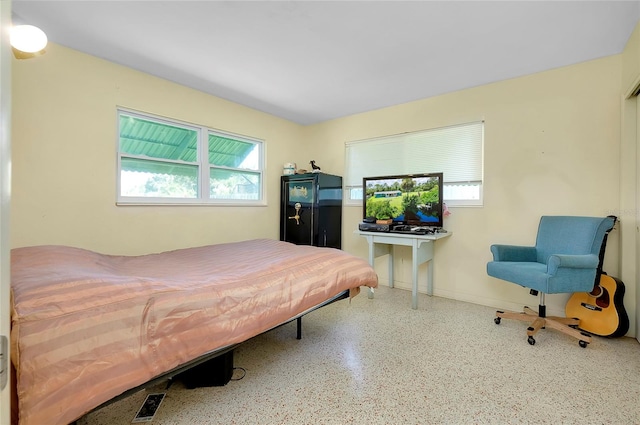 bedroom featuring multiple windows