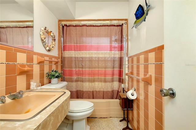 full bathroom featuring tile walls, sink, toilet, and shower / bathtub combination with curtain