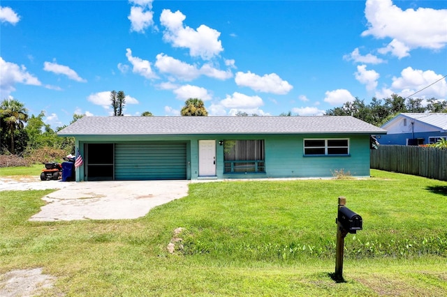 single story home featuring a front yard and a garage