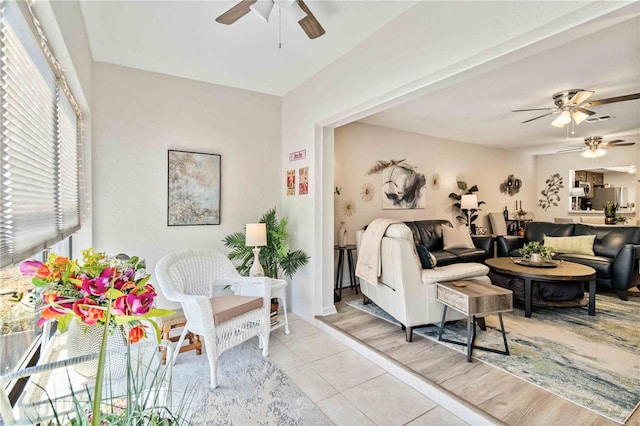 living room with light hardwood / wood-style flooring and ceiling fan