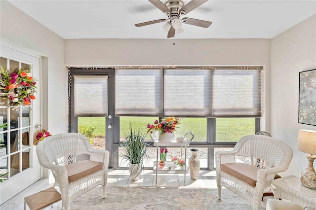 sunroom / solarium with a healthy amount of sunlight and ceiling fan