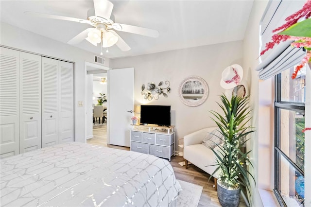 bedroom with hardwood / wood-style flooring, a closet, and ceiling fan