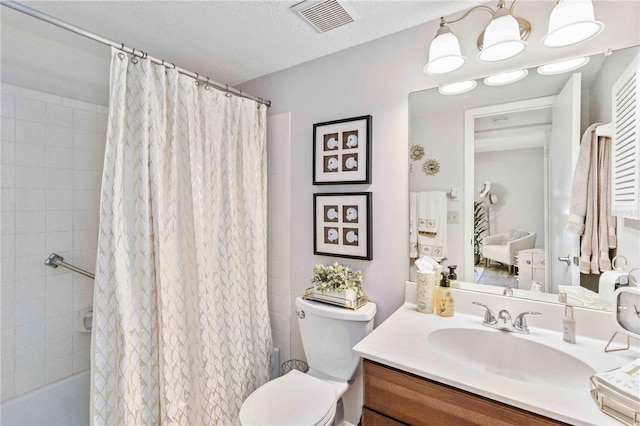 bathroom featuring vanity, toilet, a textured ceiling, and curtained shower