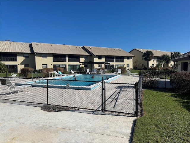 view of pool with a lawn