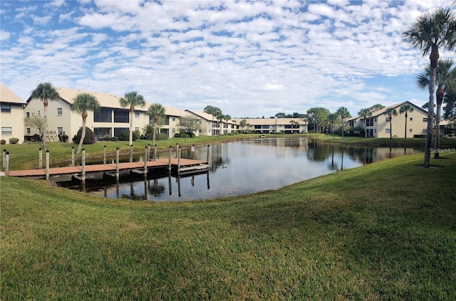 dock area featuring a water view and a yard