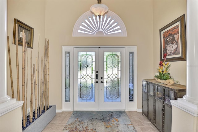 entrance foyer featuring french doors and a towering ceiling