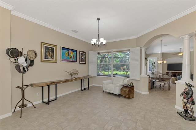 living area featuring ceiling fan with notable chandelier and ornamental molding