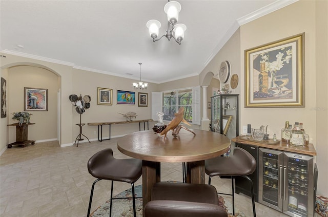 dining space featuring crown molding, wine cooler, and an inviting chandelier