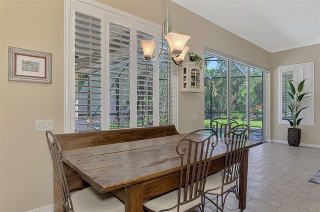 dining space with a notable chandelier and ornamental molding