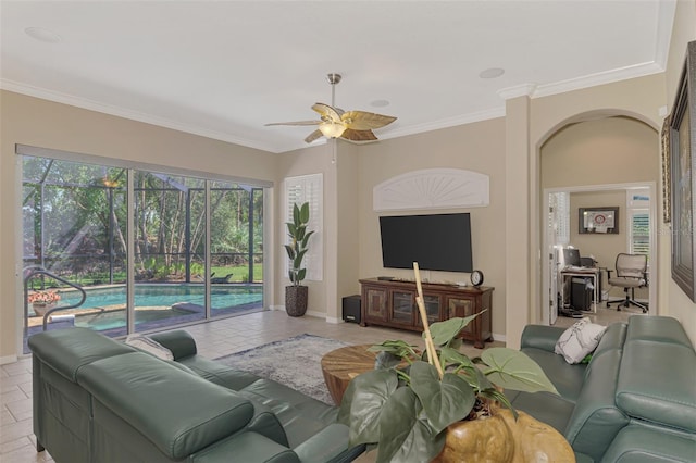 tiled living room featuring ceiling fan and crown molding