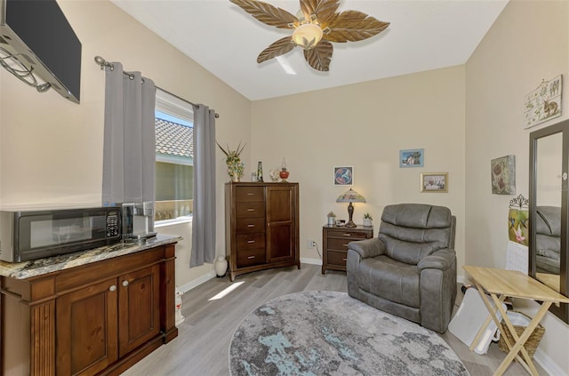 sitting room featuring ceiling fan and light wood-type flooring