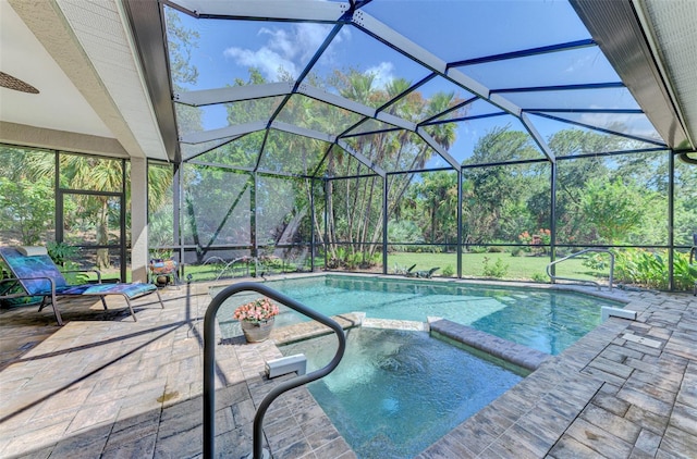 view of swimming pool with a lanai, a patio area, and an in ground hot tub