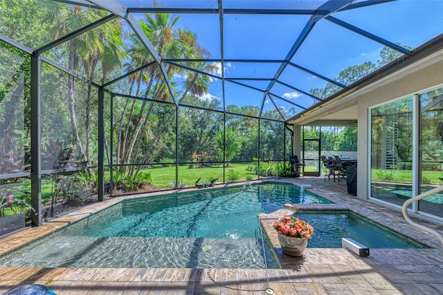 view of pool with glass enclosure, an in ground hot tub, and a patio