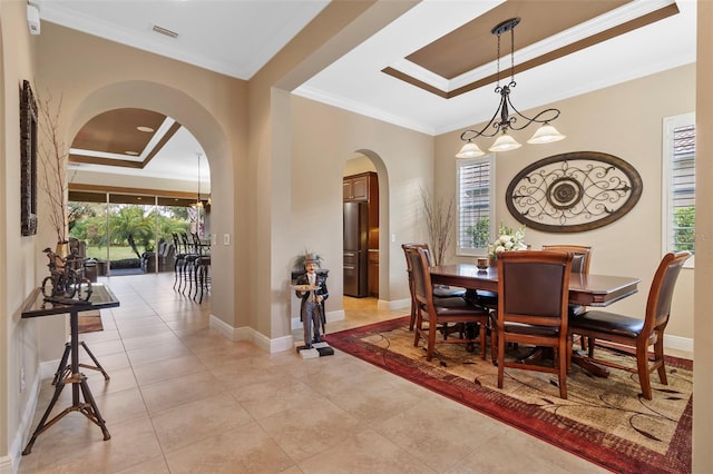 dining area featuring ornamental molding, light tile patterned flooring, an inviting chandelier, and a raised ceiling