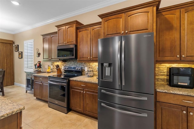 kitchen with decorative backsplash, light stone counters, light tile patterned floors, crown molding, and stainless steel appliances