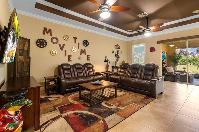 tiled living room with ceiling fan, crown molding, and a tray ceiling