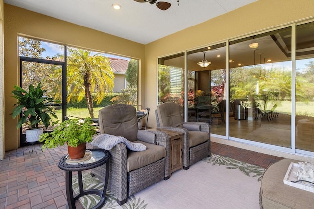 sunroom / solarium featuring ceiling fan