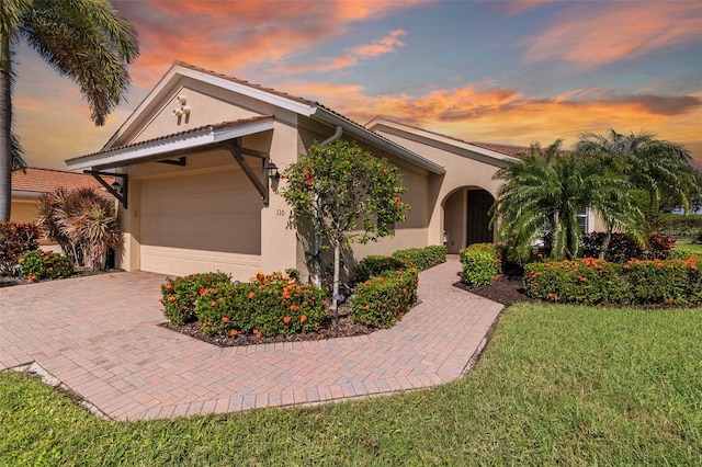 view of front of house with a yard and a garage