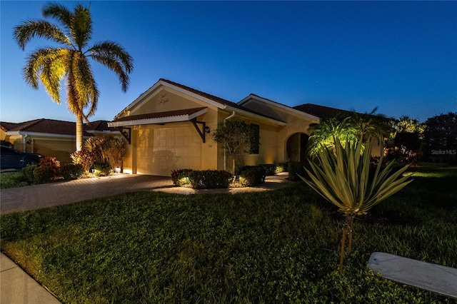 view of front of home with a front lawn and a garage