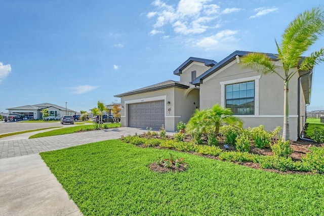 view of front of home with a front yard and a garage