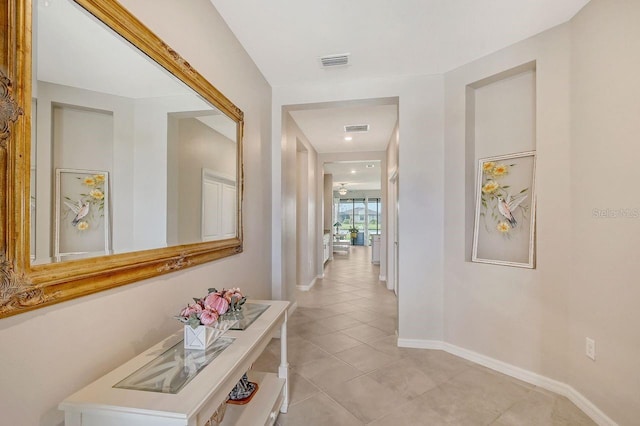 corridor featuring light tile patterned floors