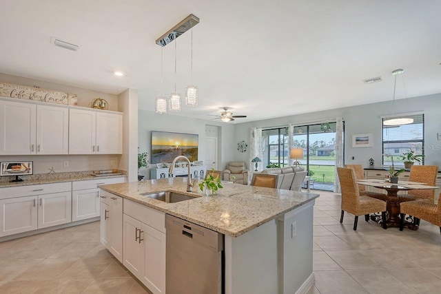 kitchen featuring sink, stainless steel dishwasher, decorative light fixtures, and white cabinets