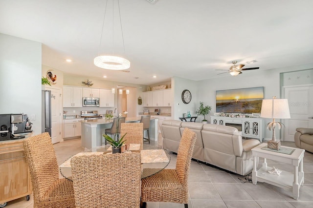 dining area with ceiling fan and light tile patterned floors