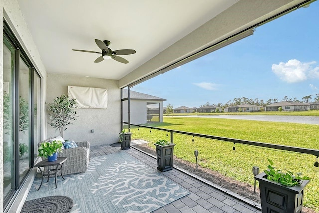 unfurnished sunroom featuring ceiling fan