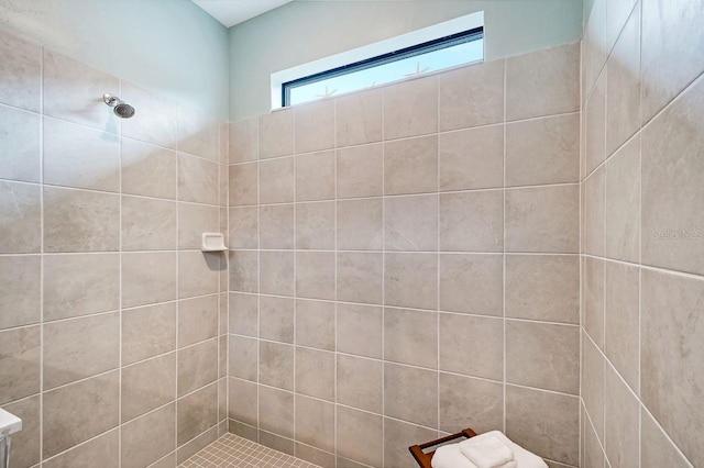 bathroom with a tile shower