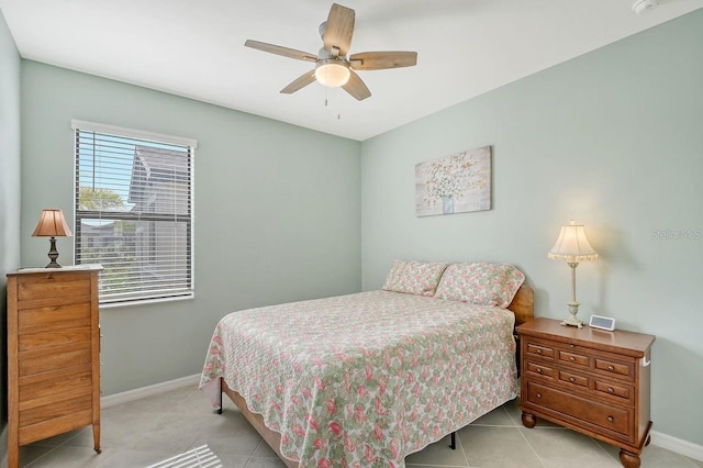 tiled bedroom featuring ceiling fan