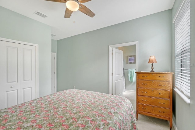 tiled bedroom featuring multiple windows, a closet, and ceiling fan