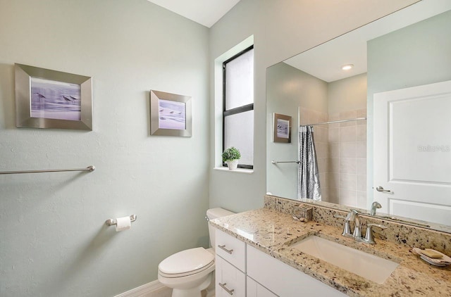 bathroom featuring vanity, a shower with shower curtain, and toilet