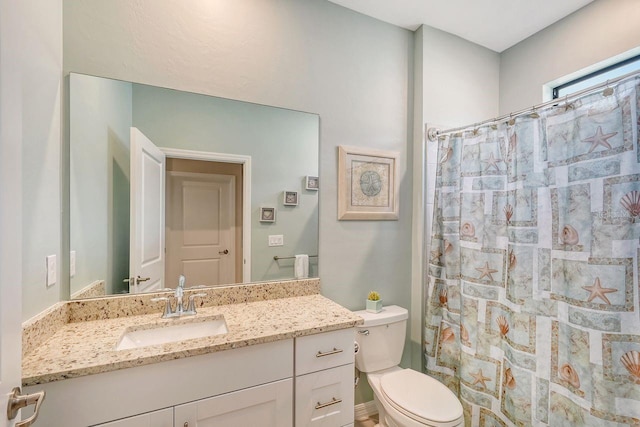 bathroom featuring vanity, toilet, and a shower with curtain