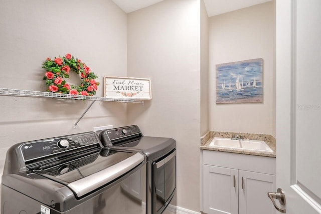 laundry room with cabinets, sink, and washing machine and clothes dryer