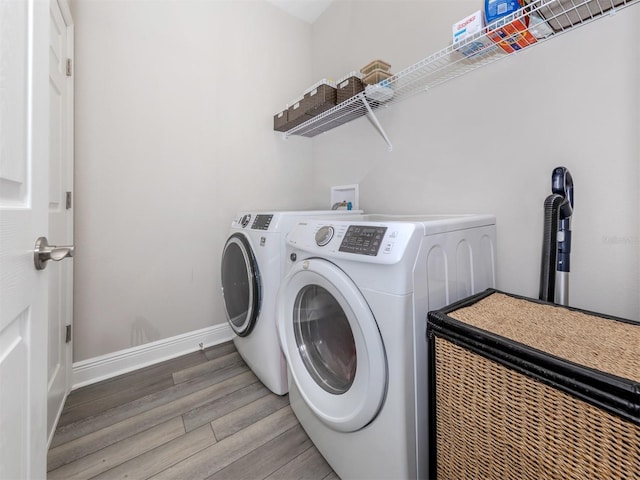 laundry room with hardwood / wood-style flooring and independent washer and dryer