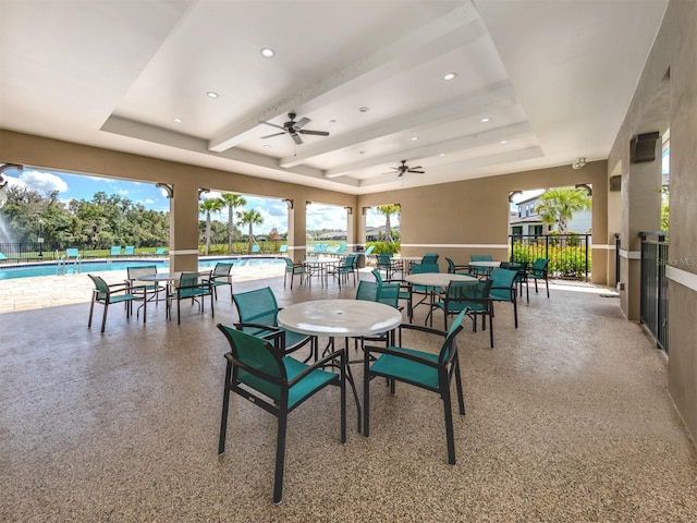 view of patio with a community pool and ceiling fan