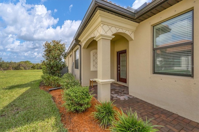 entrance to property with a yard