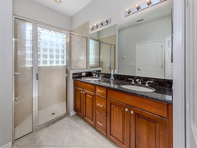 bathroom featuring vanity, an enclosed shower, and tile patterned floors