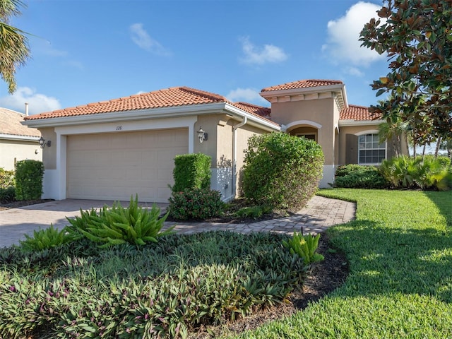 126 Cipriani Way N, Venice, FL 34275 - mediterranean / spanish home with a tiled roof, stucco siding, an attached garage, driveway, and a front yard