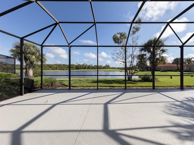 unfurnished sunroom featuring a water view