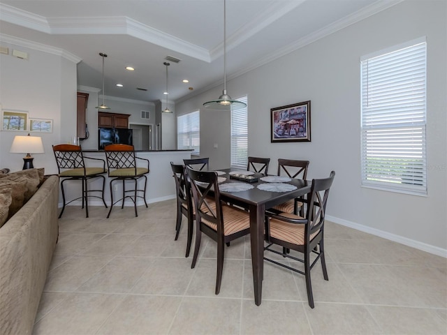 dining space with light tile patterned flooring, plenty of natural light, and ornamental molding