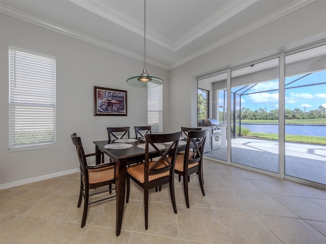 dining space with light tile patterned flooring, a water view, plenty of natural light, and ornamental molding